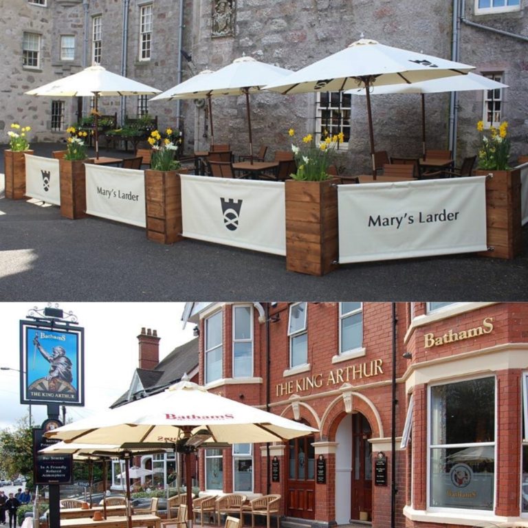 Parasols, planters and banners with logos outside a pub enhancing the pub visibility