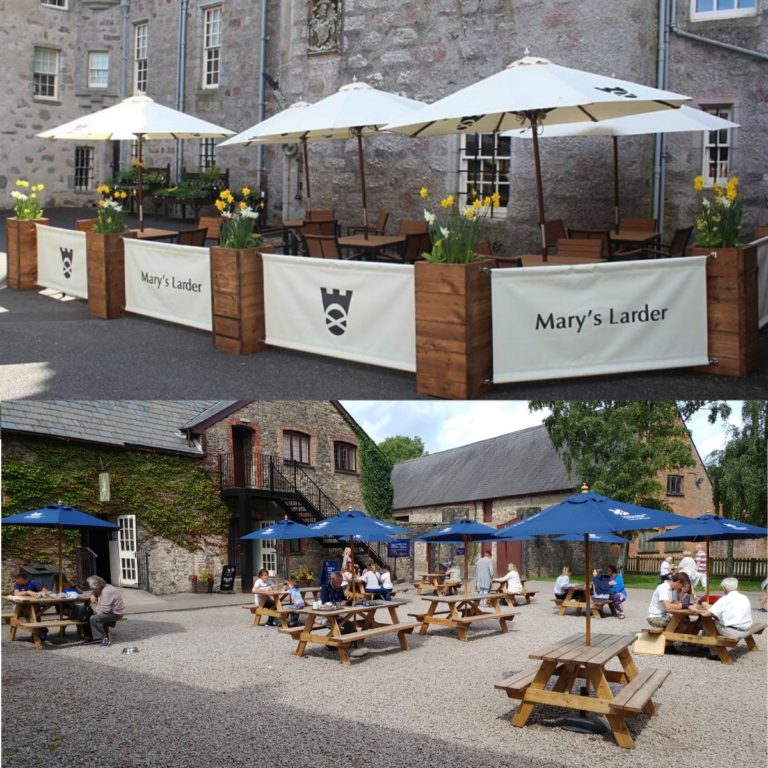 Showing branded parasols, planters and barriers at National trust scotland and picnic benches and parasols at national trust wales