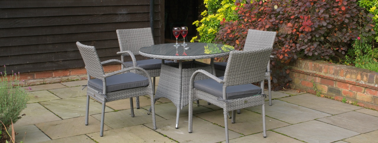 Outdoor grey rattan round dining table and chairs | Woodberry