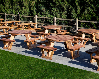 A Frame and Circular Picnic Tables Multiple Sets on Patio