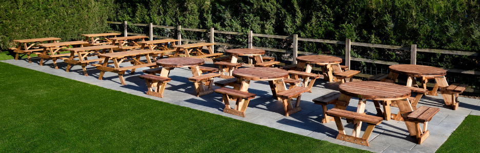 A Frame and Circular Picnic Tables Multiple Sets on Patio