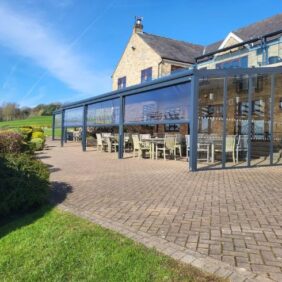 Aluminium shelter with polycarb roof and glass sides at golf club