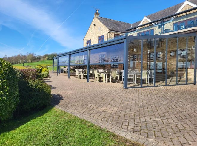 Aluminium shelter with polycarb roof and glass sides at golf club