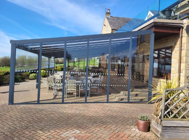 Aluminium shelter with polycarb roof and glass sides at golf club1