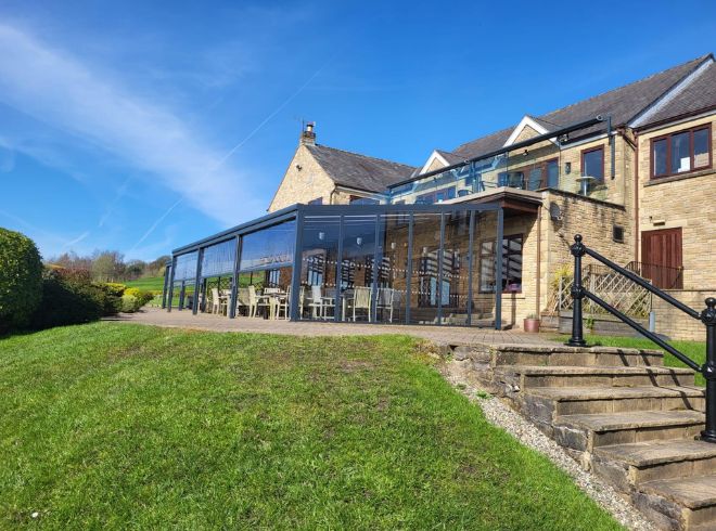 Aluminium shelter with polycarb roof and glass sides at golf club2