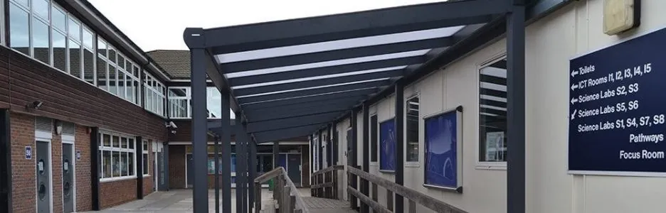 A metal framed covered walkway at a school