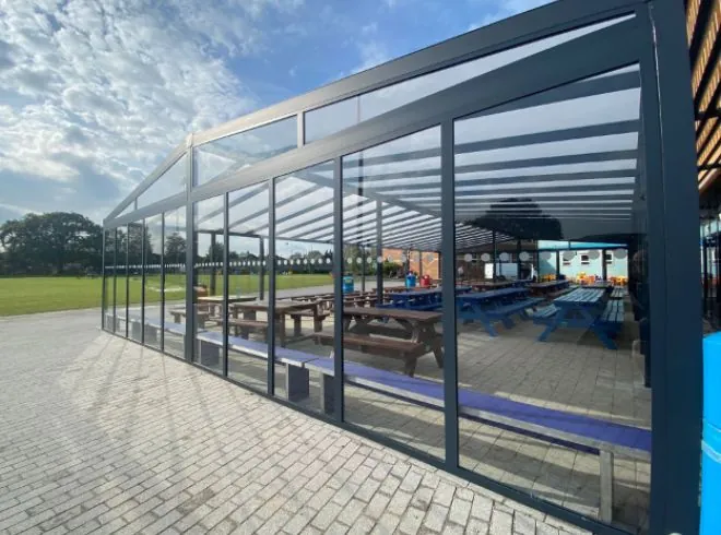 Large aluminium shelter with polycarbonate roof, and glass sides